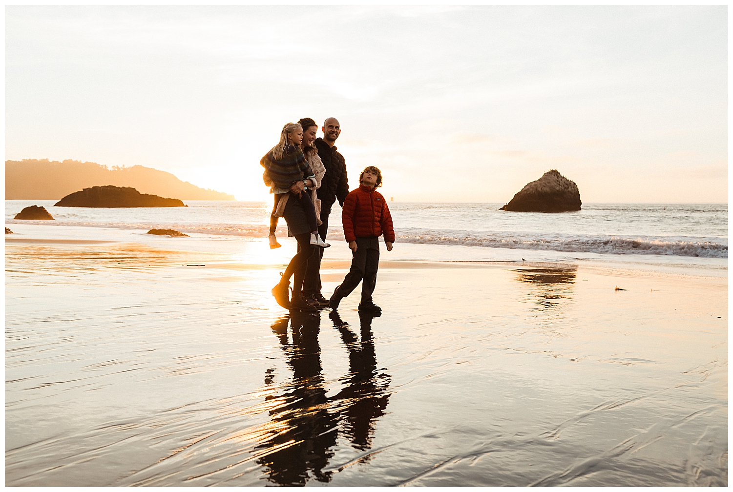 Family walking on the beach in San Francisco.
