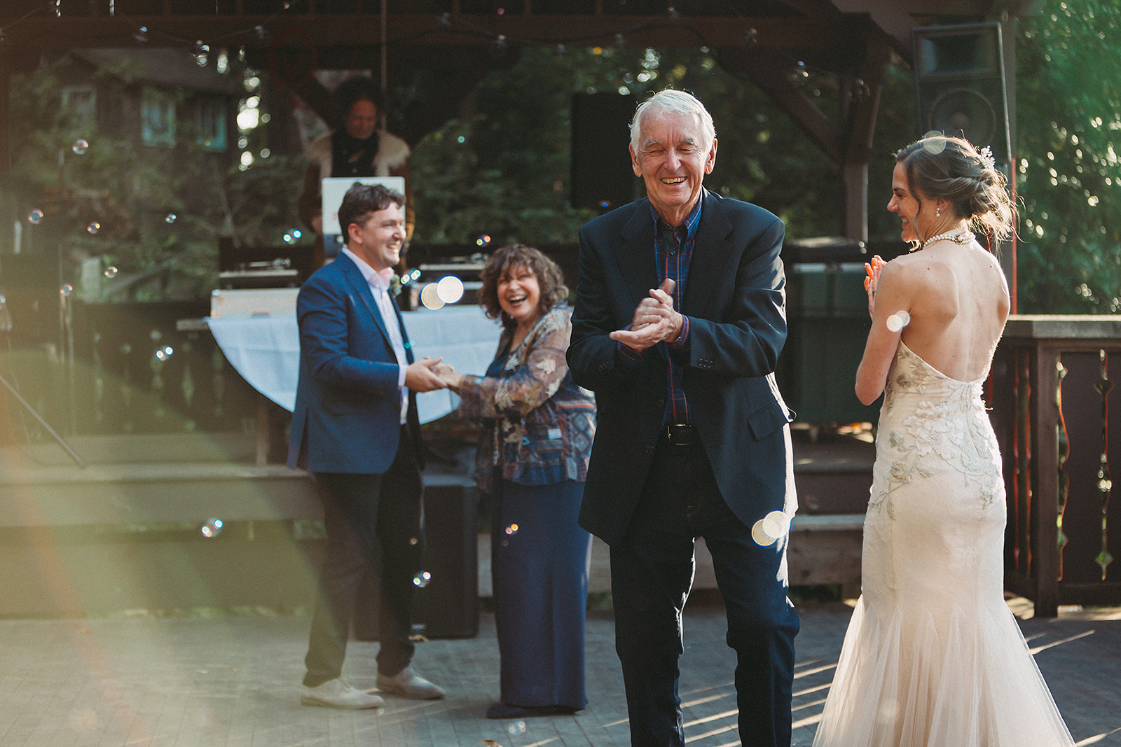 Bride and groom dancing with their parents