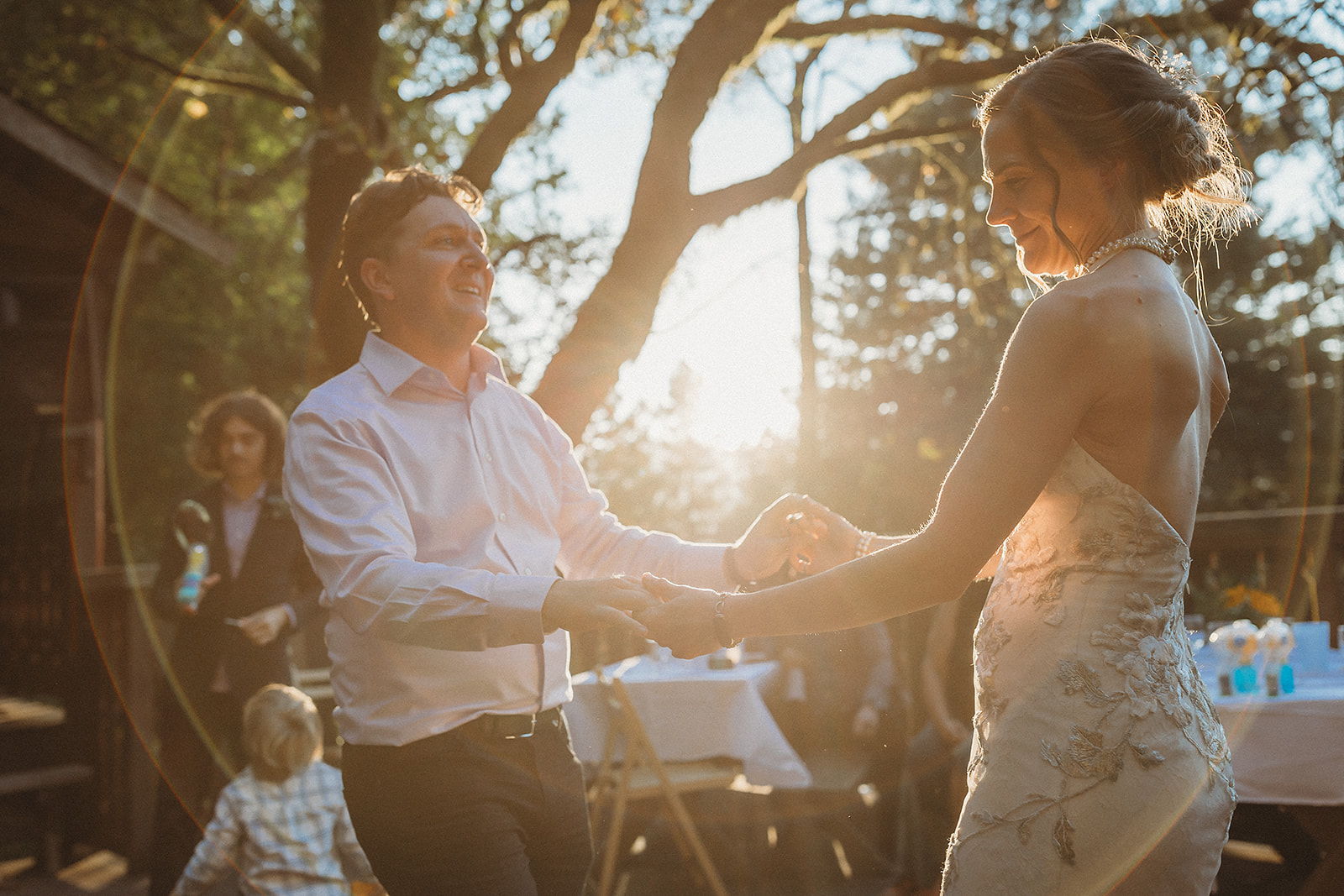 Bride and groom dancing during sunset