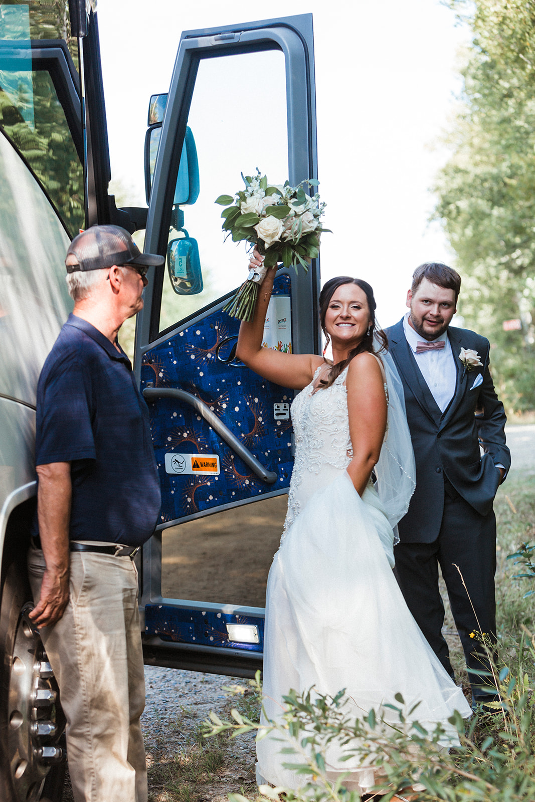 Bride and groom getting on party bus