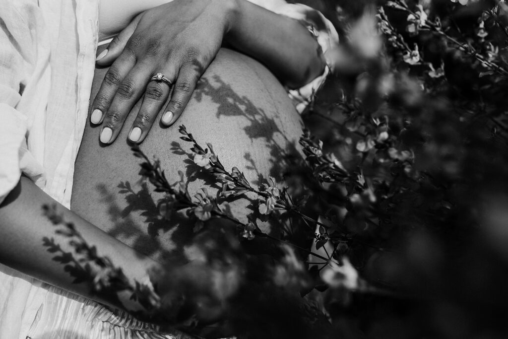 Flower shadows on pregnant woman's belly.