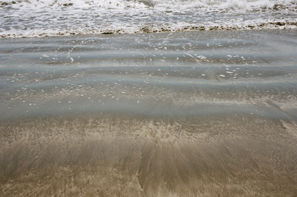 Ripples in the sand on an ocean beach near Cambria, California. Taken by Skyler Maire Photography.