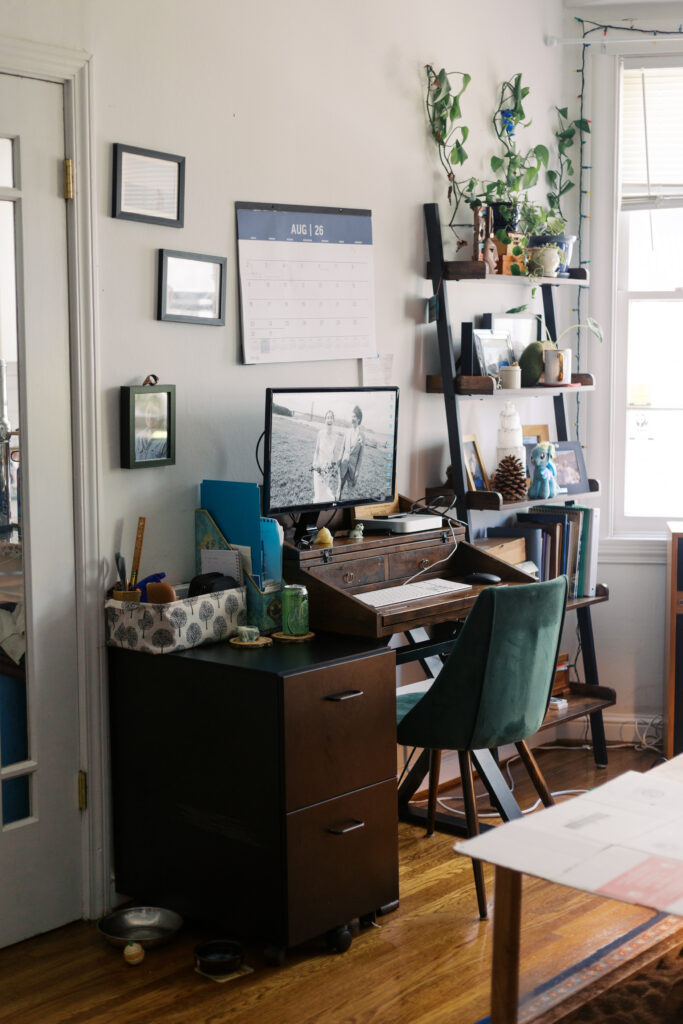 Establishing photo of a small home office space at the end of a bed in a studio apartment in San Francisco.