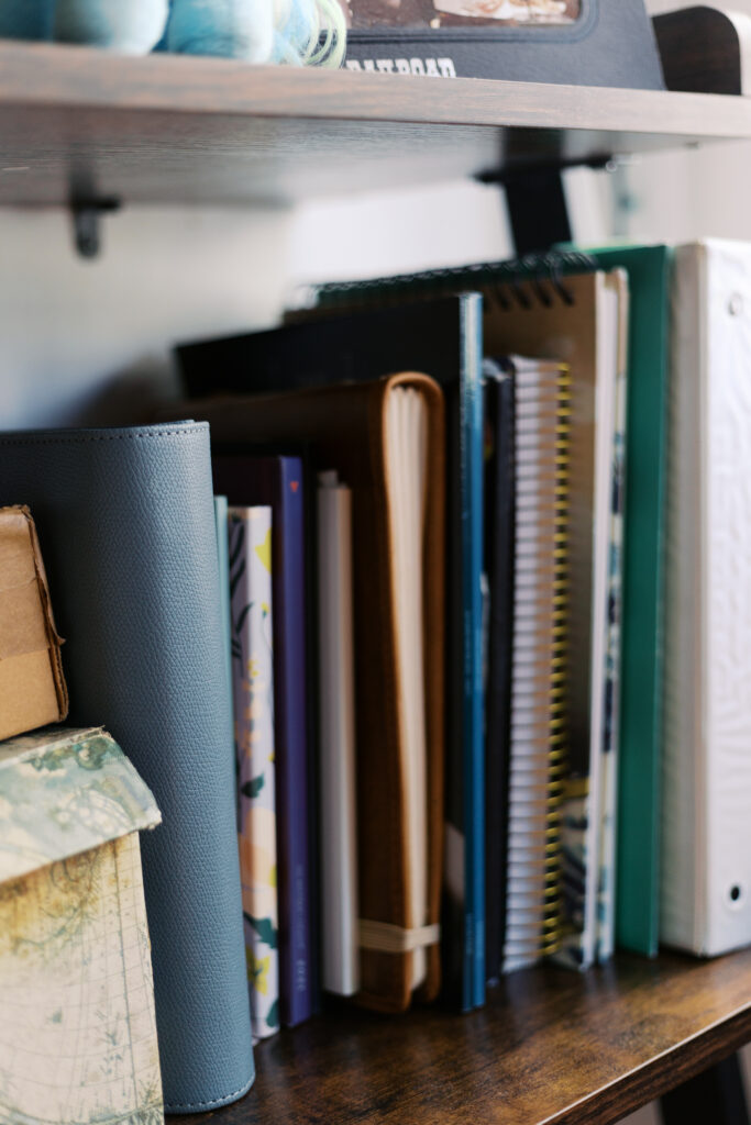 Binders and books on a shelf in a home office in San Francisco.